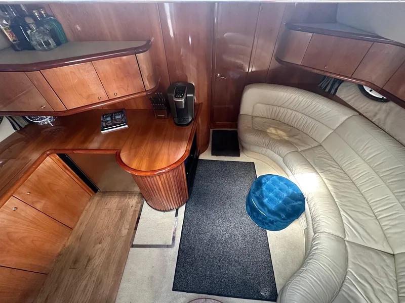 Slide: The Image of Luxurious interior of 2001 Sunseeker Camargue 44 yacht with leather seating and wooden cabinetry. - 31