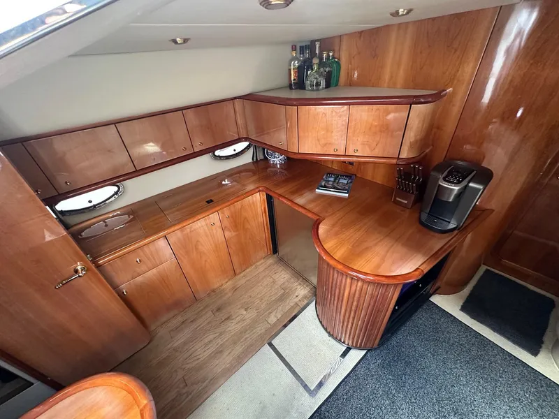 Slide: The Image of Luxurious wooden interior of 2001 Sunseeker Camargue 44 yacht with kitchenette and bar area. - 32