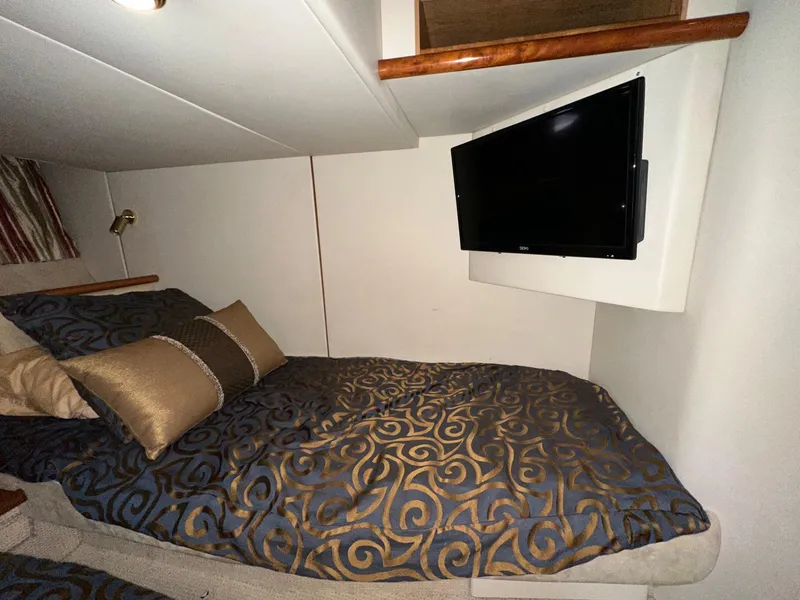 Slide: The Image of Luxurious cabin interior of 2001 Sunseeker Camargue 44 with elegant bedding and wall-mounted TV. - 39