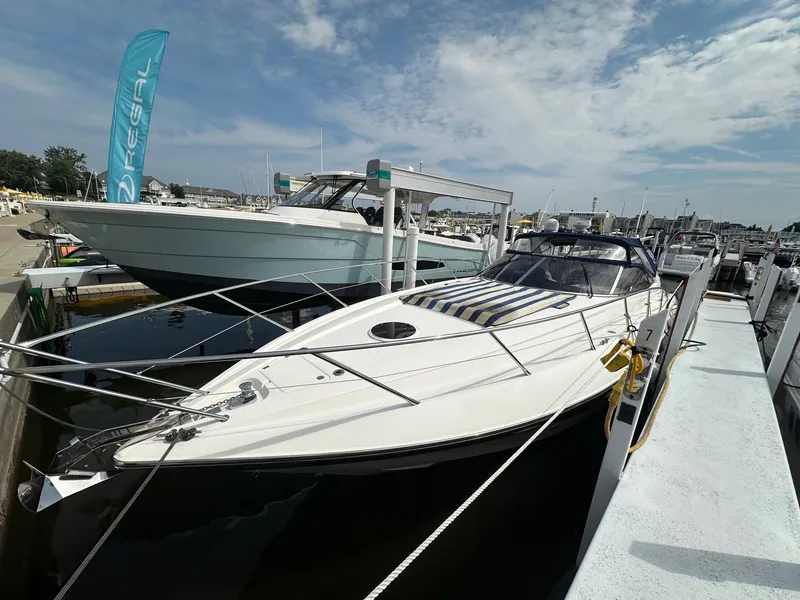 Slide: The Image of 2001 Sunseeker Camargue 44 yacht docked at marina under partly cloudy sky. - 4