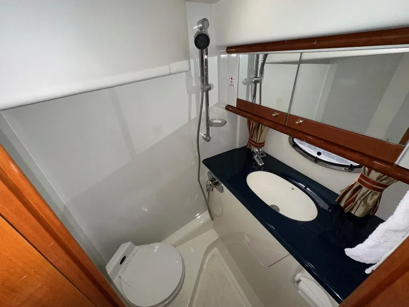 Slide: The Image of Bathroom interior of 2001 Sunseeker Camargue 44 yacht, featuring shower, sink, and mirror. - 41