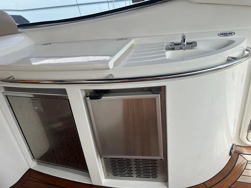 Slide: The Image of Sunseeker Camargue 44 yacht kitchenette with sink and mini fridge, 2001 model. - 42