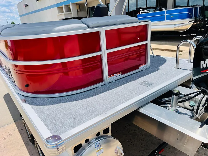Slide: The Image of 2026 Sun Tracker Party Barge 20 DLX pontoon boat with red exterior and gray deck. - 11