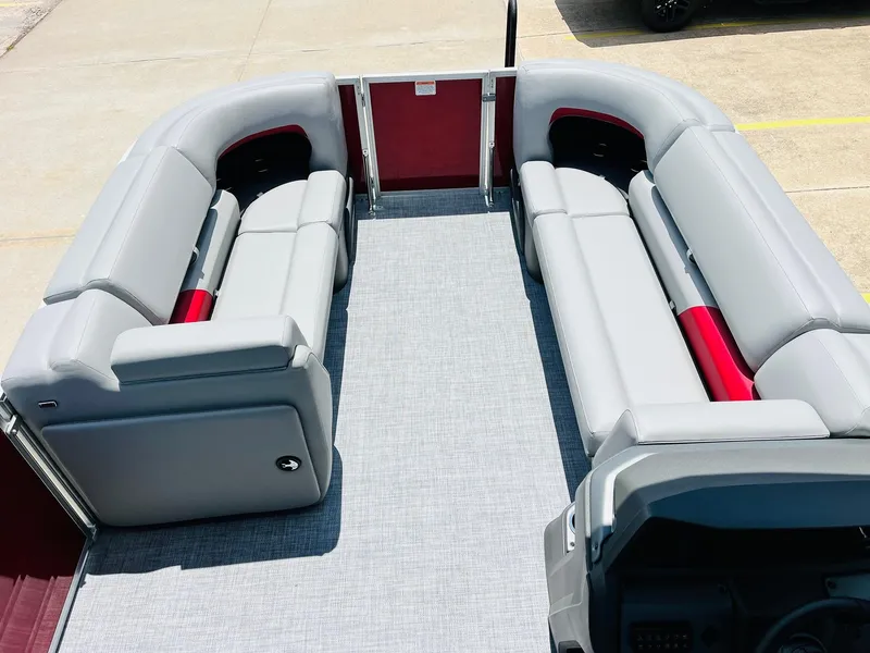 Slide: The Image of 2026 Sun Tracker Party Barge 20 DLX interior with gray seating and red accents. - 14