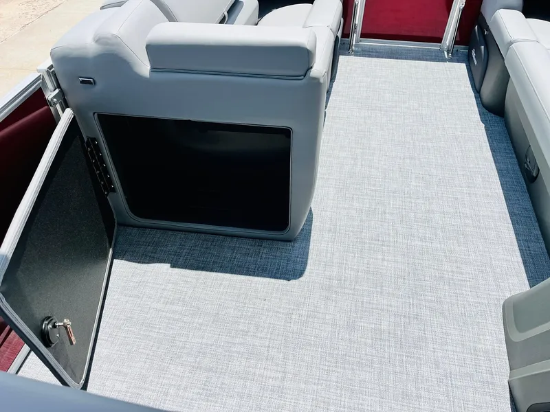 Slide: The Image of 2026 Sun Tracker Party Barge 20 DLX interior with gray seating and flooring. - 16