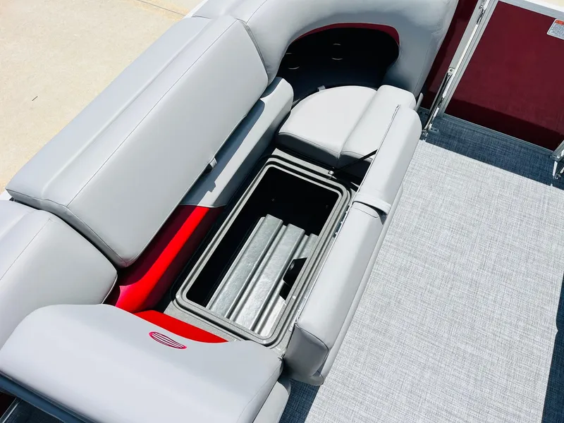 Slide: The Image of 2026 Sun Tracker Party Barge 20 DLX with open storage compartment and gray seating. - 18