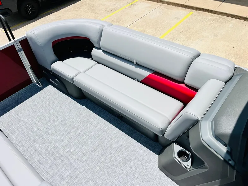 Slide: The Image of 2026 Sun Tracker Party Barge 20 DLX with sleek gray seating and red accents. - 21