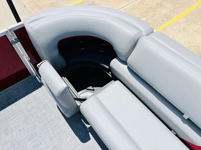 Slide: The Image of 2026 Sun Tracker Party Barge 20 DLX with gray seating and storage compartment. - 24