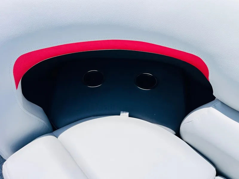 Slide: The Image of 2026 Sun Tracker Party Barge 20 DLX seating with cup holders and red accent. - 26