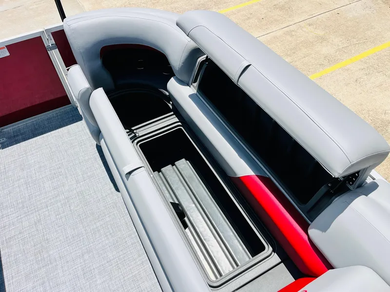 Slide: The Image of 2026 Sun Tracker Party Barge 20 DLX interior with open storage compartment. - 27