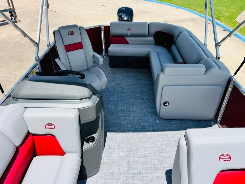 Slide: The Image of 2026 Sun Tracker Party Barge 20 DLX interior with gray and red seating, spacious layout. - 28