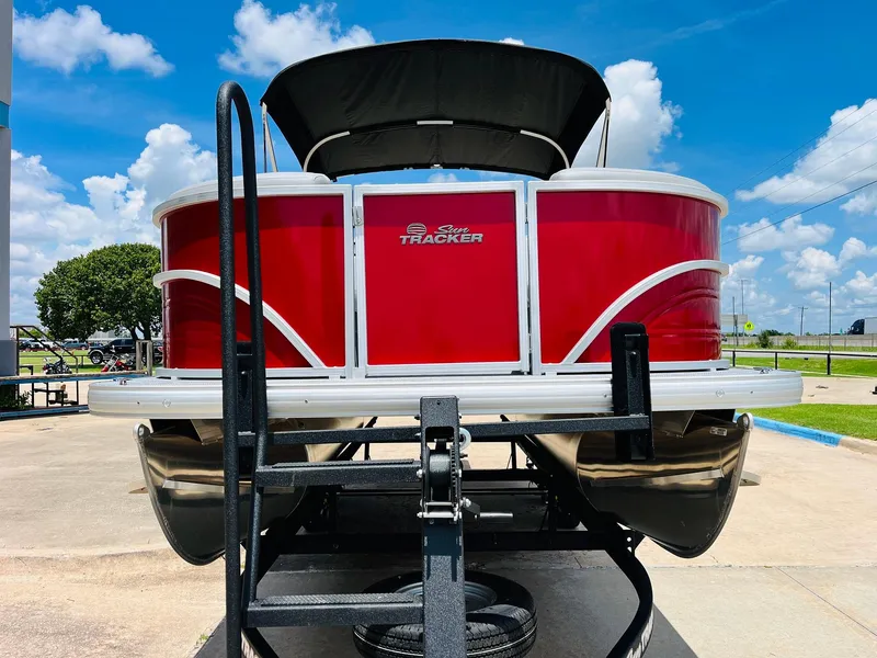 Slide: The Image of 2026 Sun Tracker Party Barge 20 DLX pontoon boat on trailer, vibrant red exterior. - 3