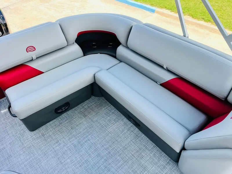 Slide: The Image of 2026 Sun Tracker Party Barge 20 DLX interior with gray and red seating. - 31