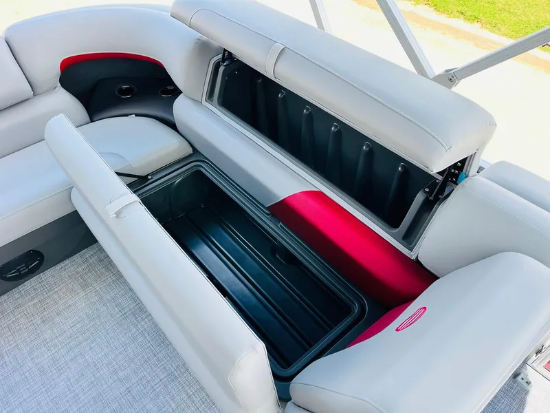 Slide: The Image of 2026 Sun Tracker Party Barge 20 DLX interior with open storage compartment and seating. - 34