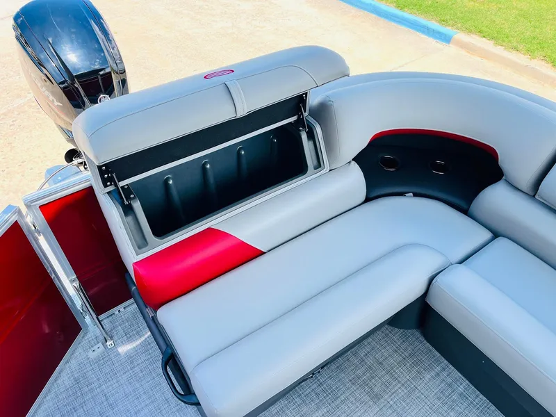 Slide: The Image of 2026 Sun Tracker Party Barge 20 DLX interior with open storage compartment and seating. - 36