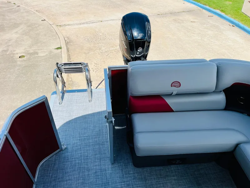 Slide: The Image of 2026 Sun Tracker Party Barge 20 DLX with seating and motor, docked on concrete. - 38