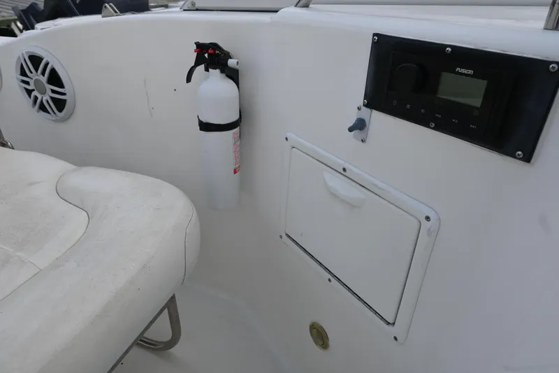 Slide: The Image of 1999 Aquasport 215 Dual Console interior with fire extinguisher, speaker, and control panel. - 16