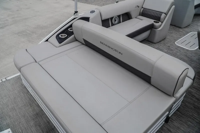 Slide: The Image of 2021 Bennington 22SSBXP pontoon boat interior with plush seating and cup holders. - 6