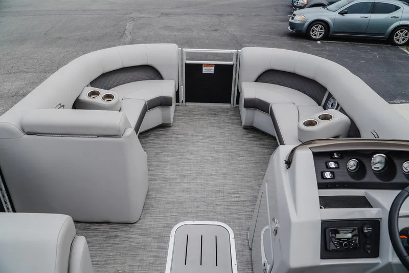 Slide: The Image of 2021 Bennington 22SSBXP pontoon boat interior with plush seating and cup holders. - 7