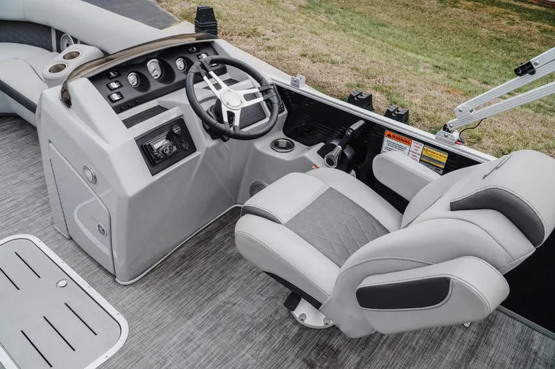 Slide: The Image of 2021 Bennington 22SSBXP boat interior with steering wheel and captain's chair. - 8