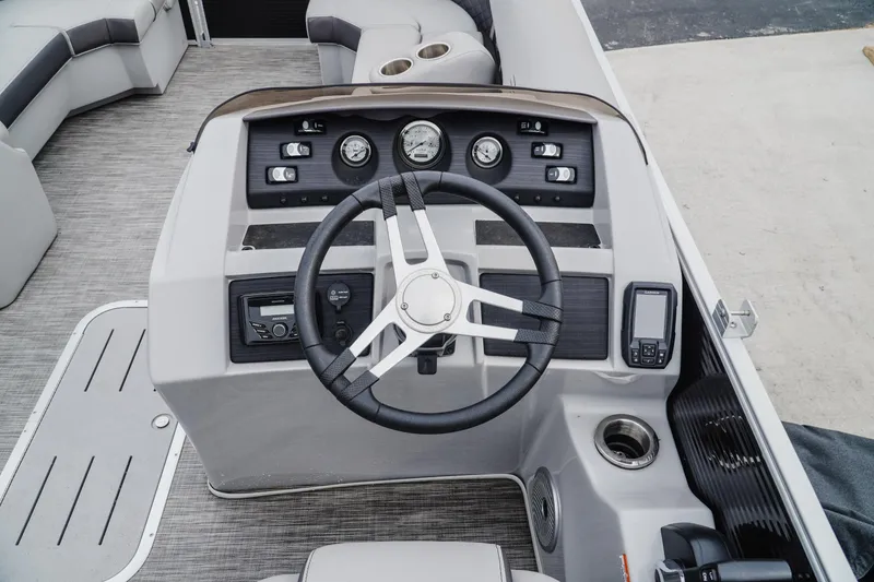 Slide: The Image of 2021 Bennington 22SSBXP boat dashboard with steering wheel and control panel. - 9