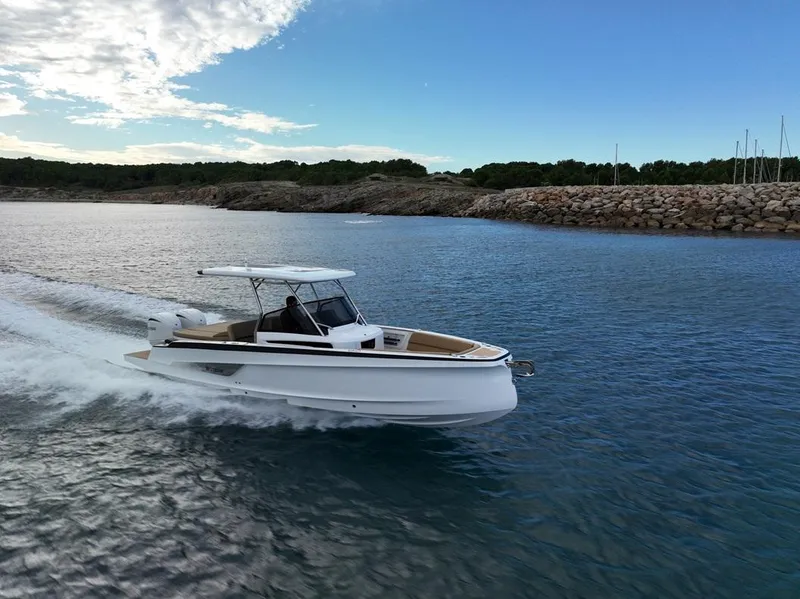 Slide: The Image of 2026 STERK 31 WB Super Sport boat cruising on a calm coastal waterway. - 12