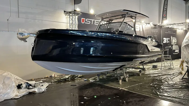 Slide: The Image of 2026 STERK 31 WB Super Sport boat displayed at an indoor exhibition. - 38