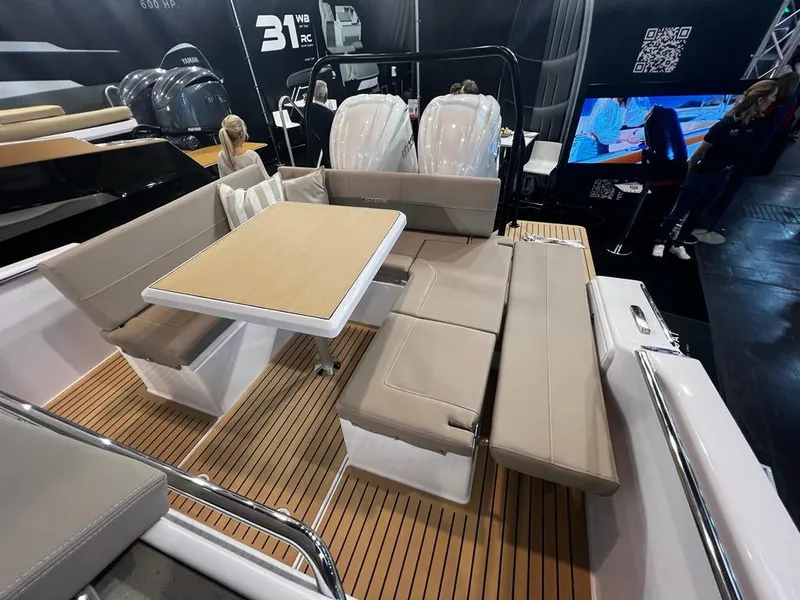 Slide: The Image of 2026 STERK 31 WB Super Sport boat interior with seating and table on teak deck. - 39