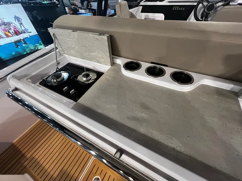 Slide: The Image of Outdoor kitchen on 2026 STERK 31 WB Super Sport boat with stove and cup holders. - 40