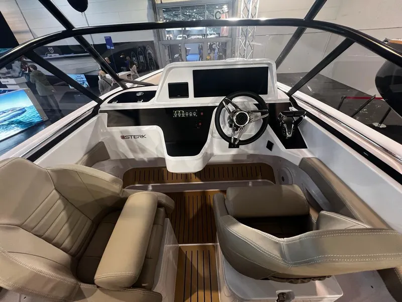 Slide: The Image of 2026 STERK 31 WB Super Sport boat interior with modern dashboard and beige seating. - 42