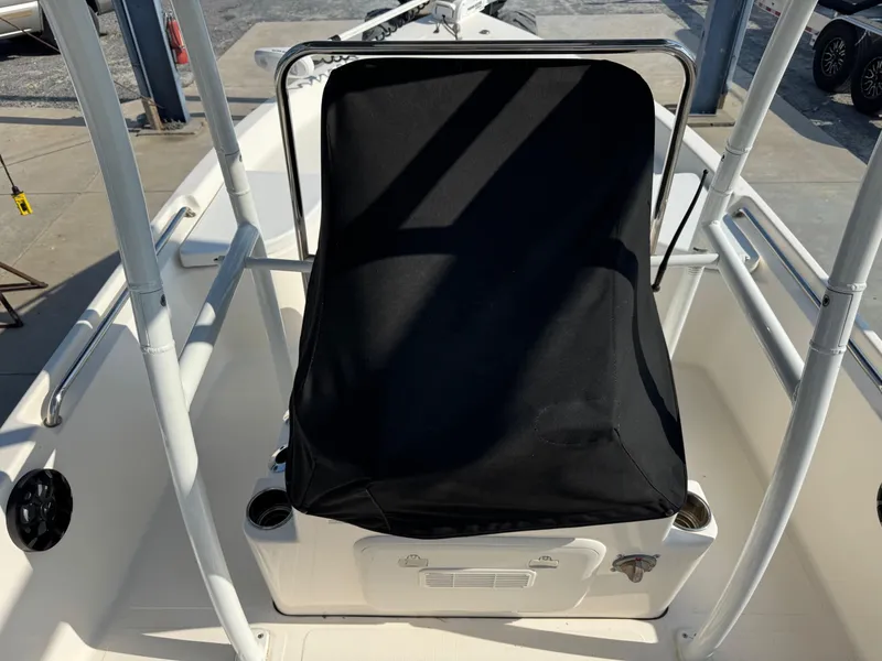Slide: The Image of 2019 Bulls Bay 2000 boat console with black cover, surrounded by white railing. - 11