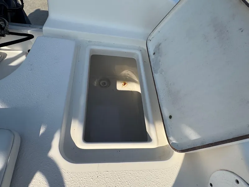 Slide: The Image of Open storage compartment on a 2019 Bulls Bay 2000 boat, showing interior details. - 12