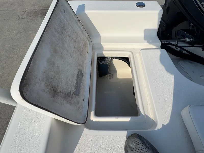 Slide: The Image of Open storage compartment on a 2019 Bulls Bay 2000 boat, showing interior details. - 13