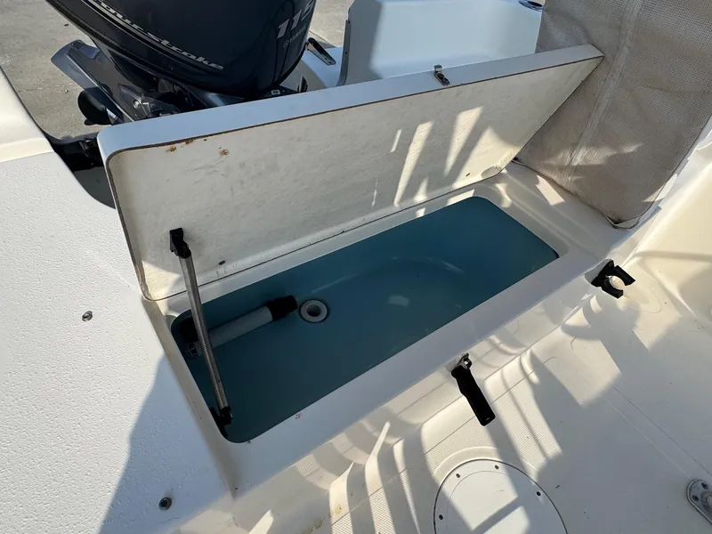 Slide: The Image of 2019 Bulls Bay 2000 boat with open storage compartment and Yamaha outboard motor. - 14
