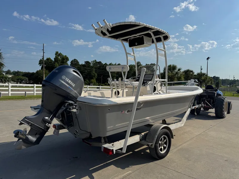 Slide: The Image of 2019 Bulls Bay 2000 boat on trailer with Yamaha outboard motor, parked outdoors. - 4