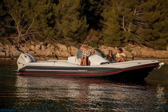 Slide: The Image of 2025 Zar Formenti 85 SL boat cruising near a forested shoreline. - 1