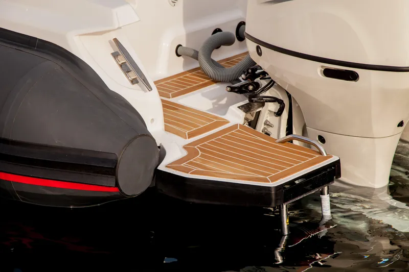 Slide: The Image of Zar Formenti 85 SL 2025 boat stern with teak deck and outboard motor. - 12