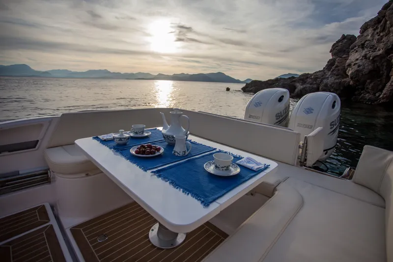 Slide: The Image of Luxury dining setup on Zar Formenti 85 SL boat, 2025 model, with scenic ocean view. - 13