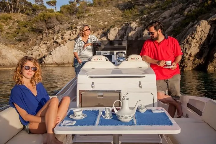 Slide: The Image of 2025 Zar Formenti 85 SL boat with people enjoying tea on deck in a scenic cove. - 18