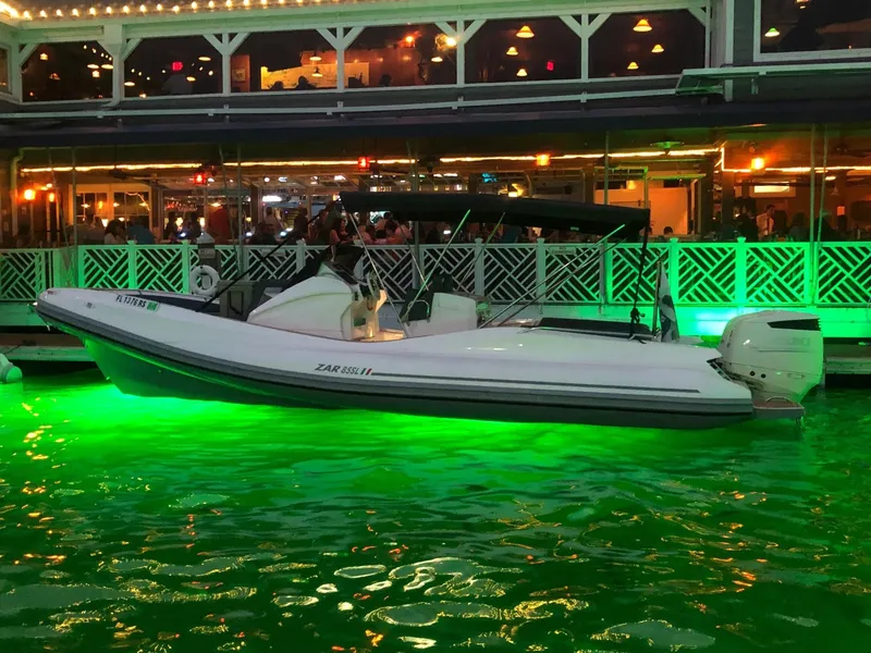 Slide: The Image of 2025 Zar Formenti 85 SL boat illuminated by green underwater lights at night. - 3