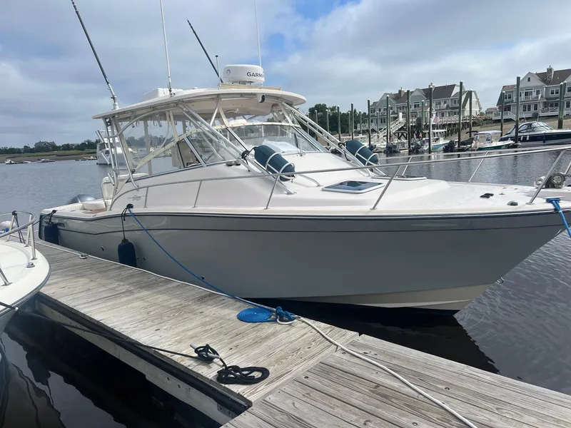 Slide: The Image of 2007 Grady-White Express 330 boat docked at marina, clear sky background. - 1
