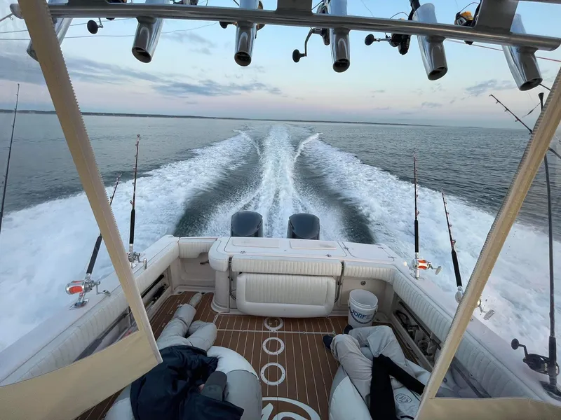 Slide: The Image of 2007 Grady-White Express 330 boat cruising on open water, fishing rods visible. - 12