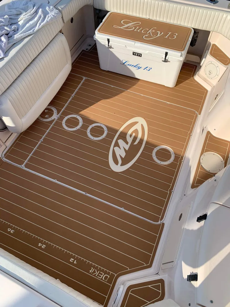 Slide: The Image of 2007 Grady-White Express 330 boat deck with custom flooring and cooler, labeled "Lucky 13." - 13