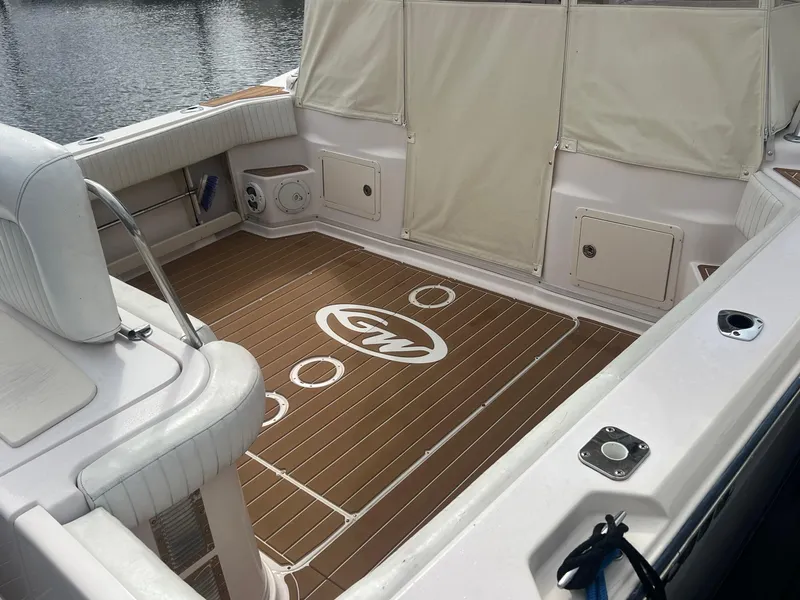 Slide: The Image of 2007 Grady-White Express 330 boat interior with teak flooring and cushioned seating. - 15