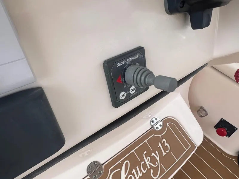 Slide: The Image of Control panel of a 2007 Grady-White Express 330 boat with joystick and "Lucky 13" label. - 17