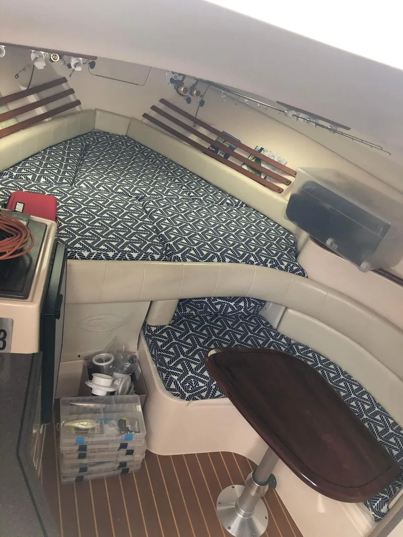 Slide: The Image of Interior of 2007 Grady-White Express 330 boat with patterned cushions and wooden table. - 20