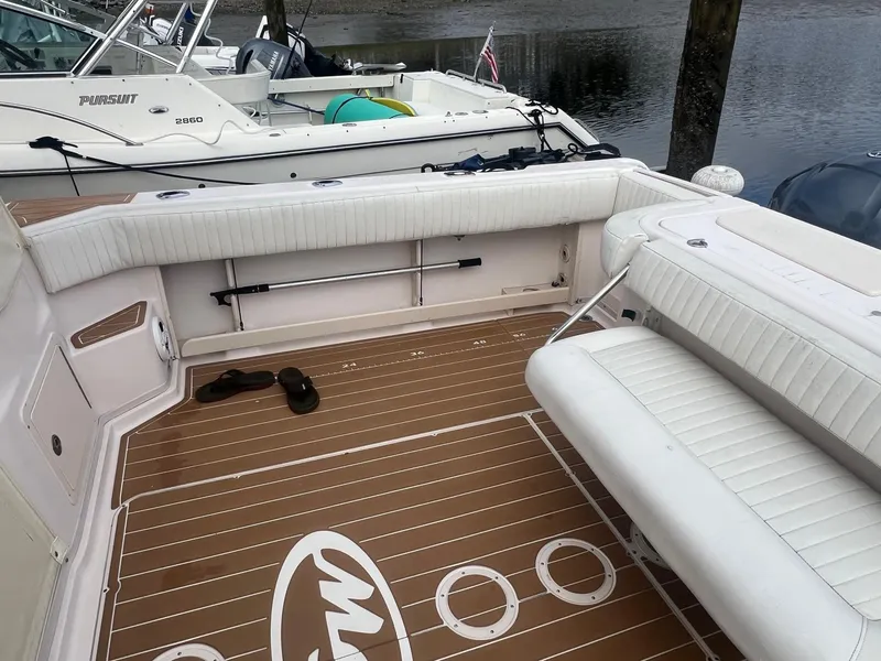 Slide: The Image of 2007 Grady-White Express 330 boat interior with white seating and teak-style flooring. - 4