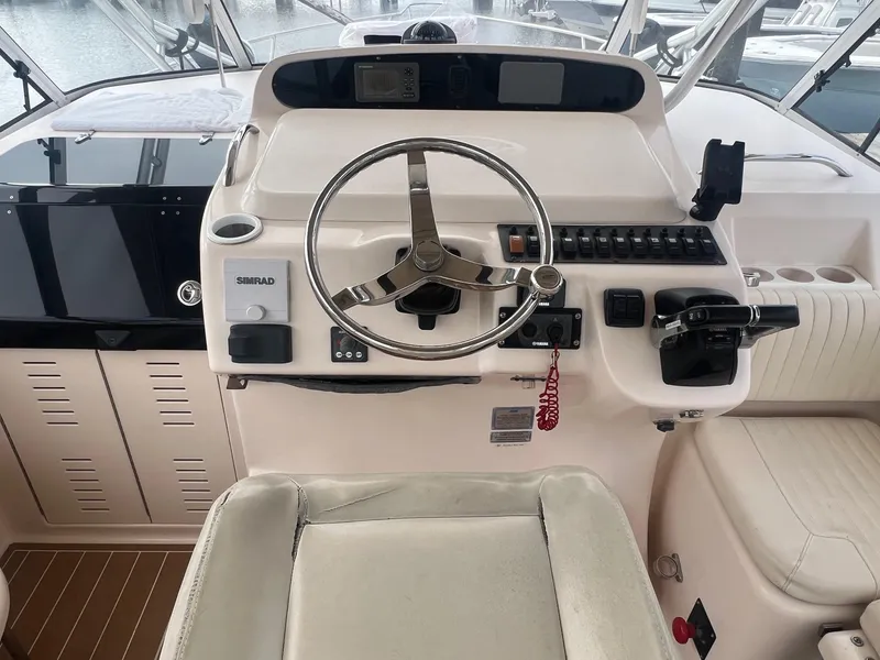 Slide: The Image of 2007 Grady-White Express 330 helm with steering wheel, controls, and navigation equipment. - 6