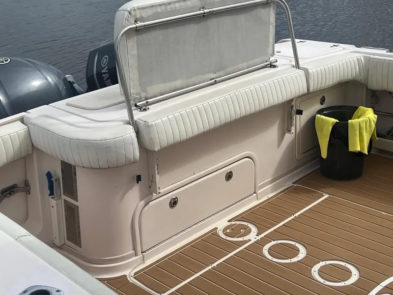 Slide: The Image of 2007 Grady-White Express 330 boat interior with cushioned seating and teak-style flooring. - 9