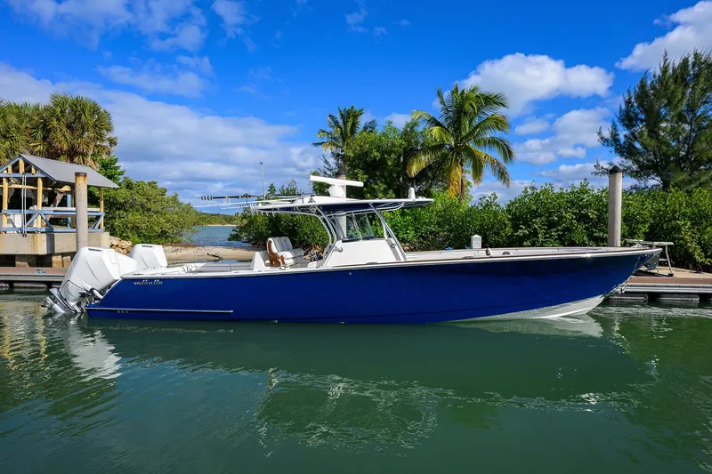 The Image of 2025 Valhalla Boatworks V-41 in marina, blue hull, tropical backdrop. - 0